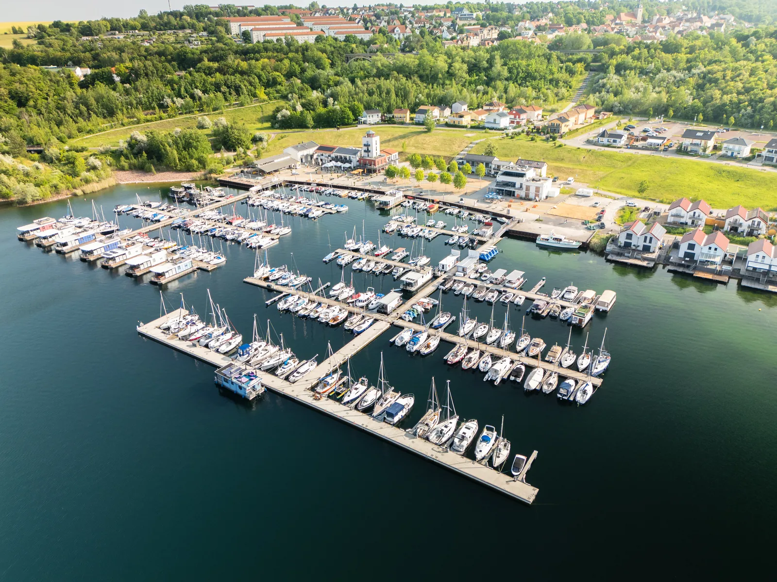 Aerial view of Marina Mücheln on Lake Geiseltalsee with boat jetties, harbour buildings and holiday homes on the shore